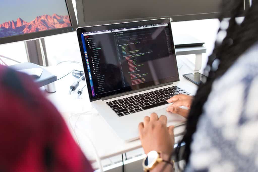 back end developer looking at lines of code on a laptop screen