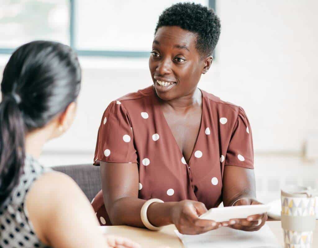 A woman asking a candidate some behavioral interview questions