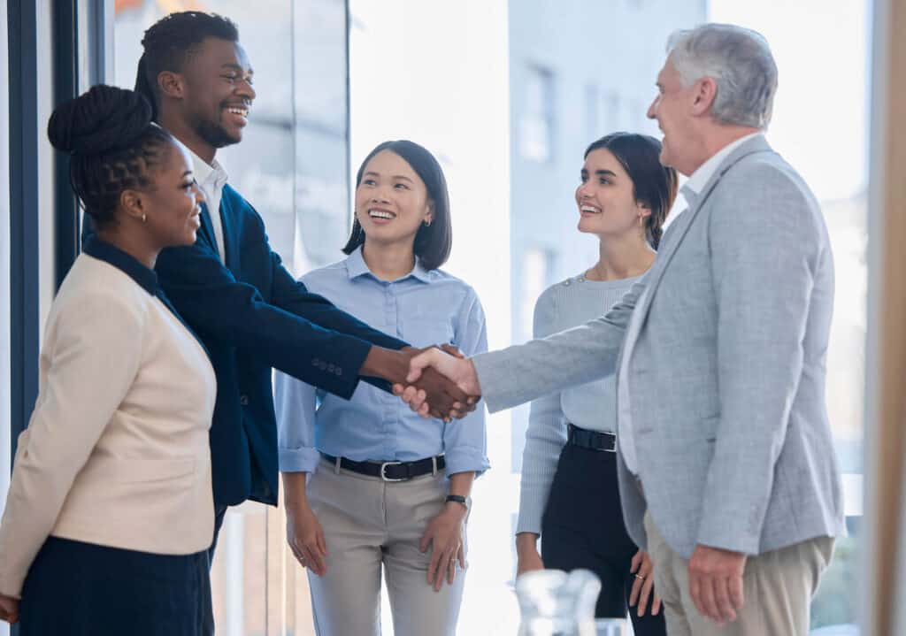 businesspeople shake hands after negotiating a business deal