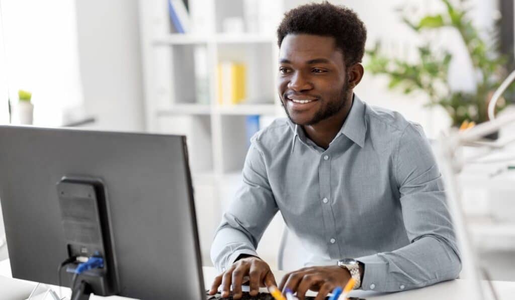 student sitting at computer typing