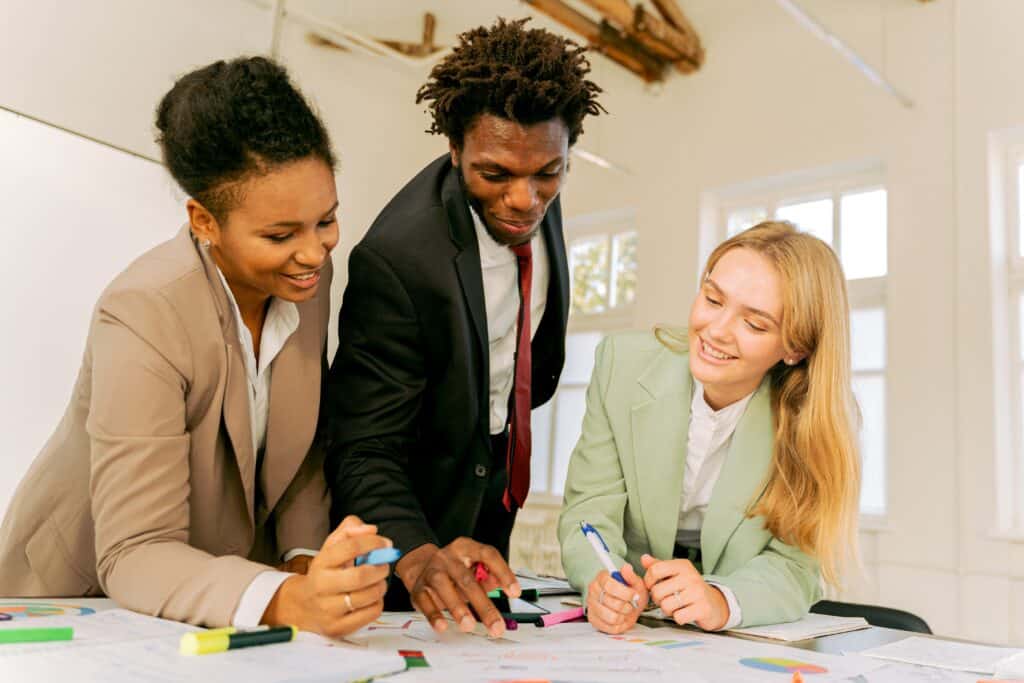 three employees communicating at work