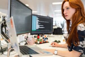 web developer working on code with computers in front of them