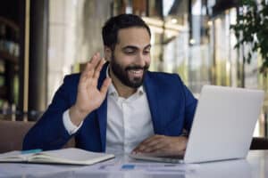 person with Zoom interview attire waving at screen