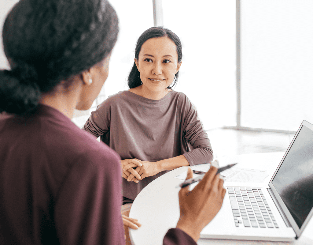 technical recruiter looking at candidate with laptop in front of them